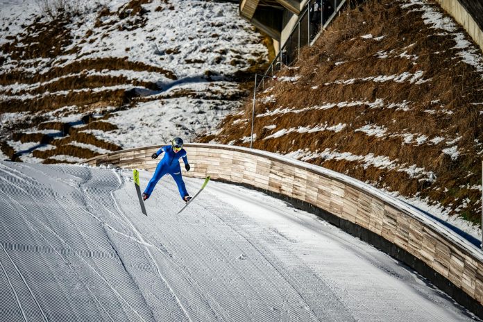 A thrilling ski jumper in vibrant blue suit captures the essence of winter sports at Planica.